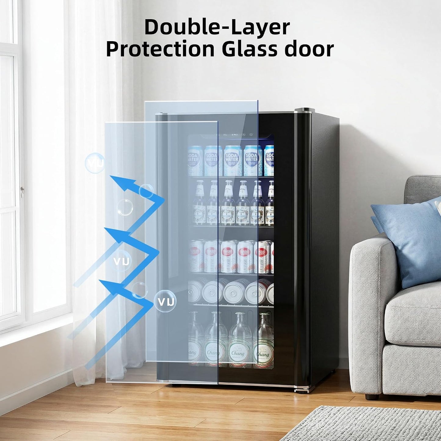 A compact black beverage refrigerator with a transparent double-layer glass door, shown in a bright living room setting with a sofa and window. Blue graphic arrows and the text 'Double-Layer Protection Glass door' illustrate the glass feature.
