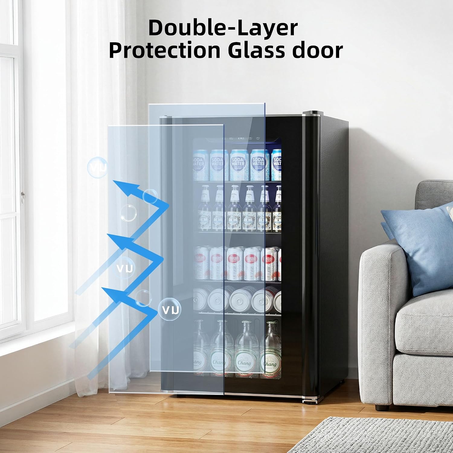 A compact black beverage refrigerator with a transparent double-layer glass door, shown in a bright living room setting with a sofa and window. Blue graphic arrows and the text 'Double-Layer Protection Glass door' illustrate the glass feature.