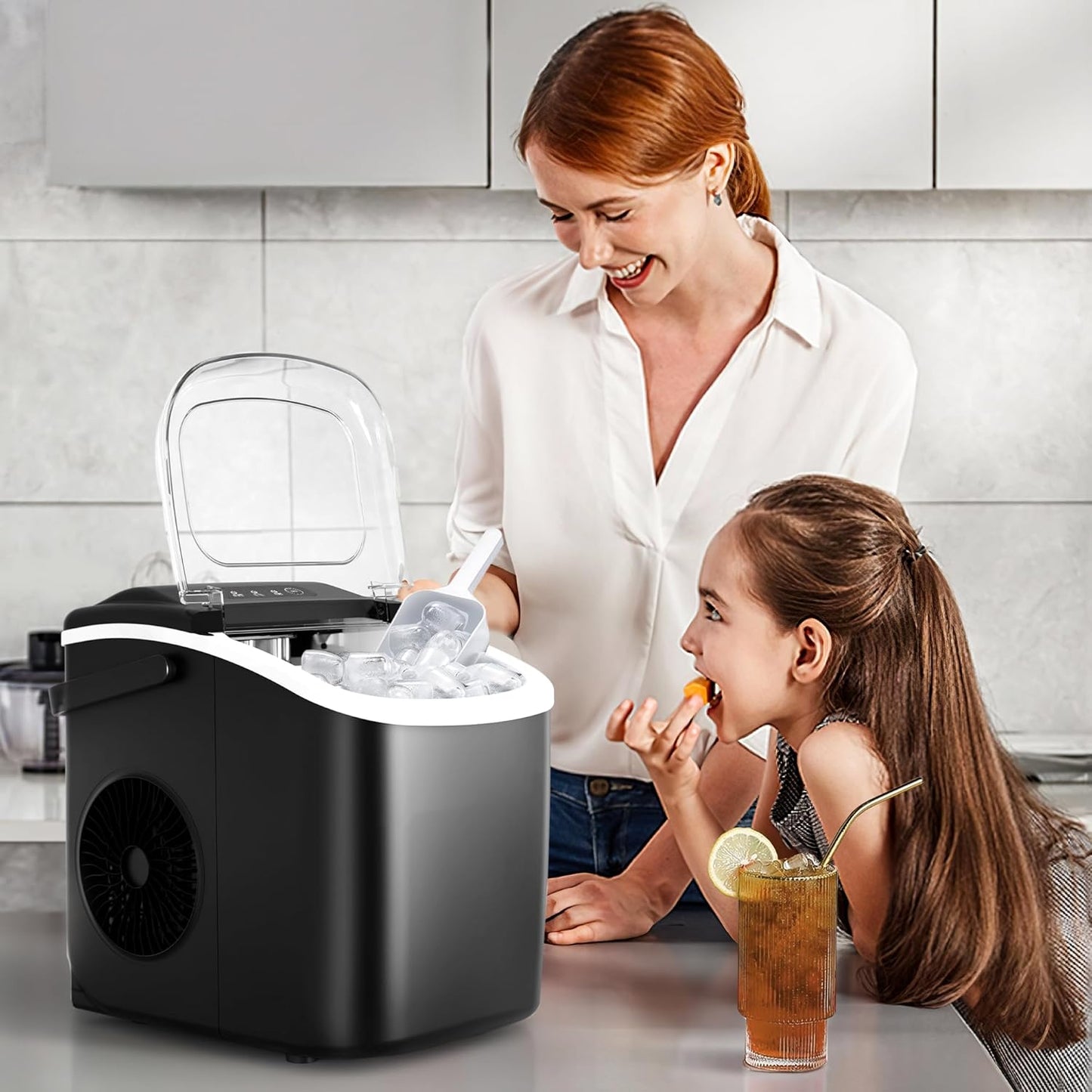 Woman and child in a kitchen with a portable ice maker.