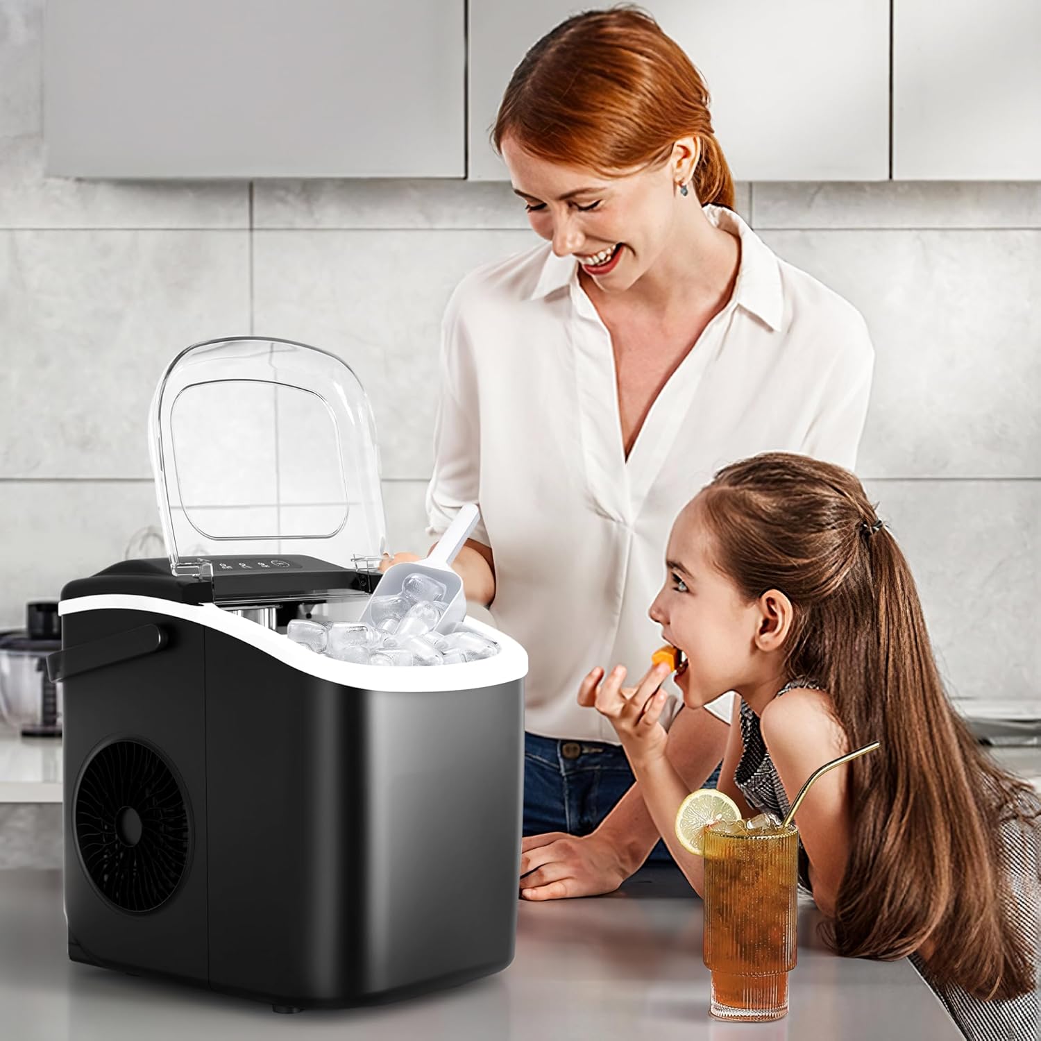 Woman and child in a kitchen with a portable ice maker.